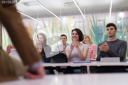 Image of teacher with a group of students in classroom