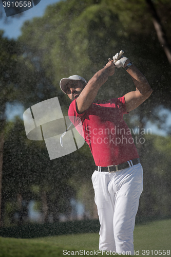 Image of golfer hitting a sand bunker shot