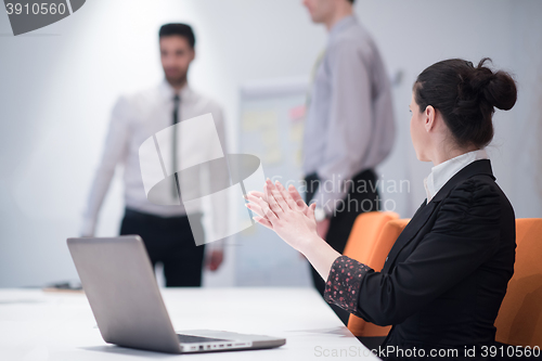 Image of young business woman on meeting  using laptop computer