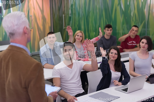 Image of teacher with a group of students in classroom