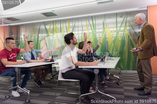 Image of teacher with a group of students in classroom