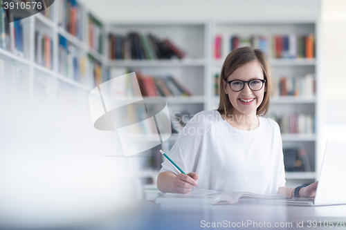 Image of female student study in school library