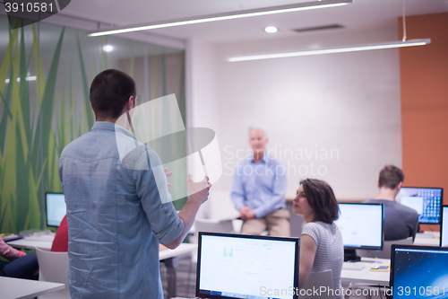 Image of student answering a question in classroom