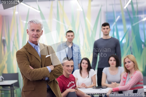 Image of portrait of  teacher with students group in background