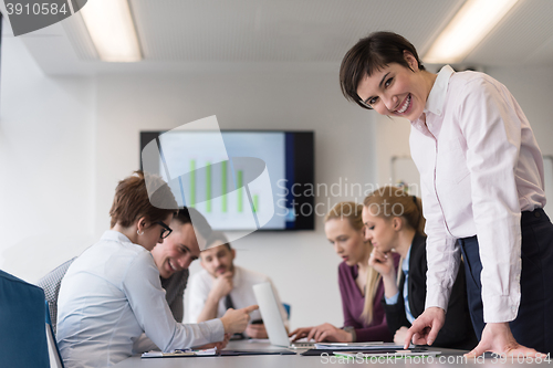 Image of young  woman using  tablet on business meeting