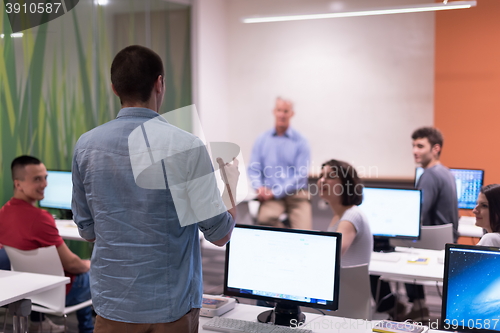 Image of student answering a question in classroom