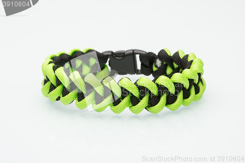 Image of green braided bracelet on white background