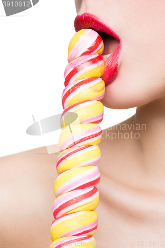 Image of Close-up shot of woman\'s mouth bright red lips with lollipop. blowjob simulation