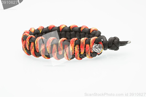 Image of black and orange braided bracelet on white background