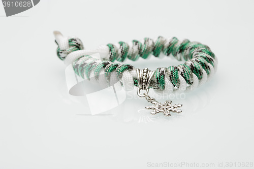 Image of green braided bracelet on white background