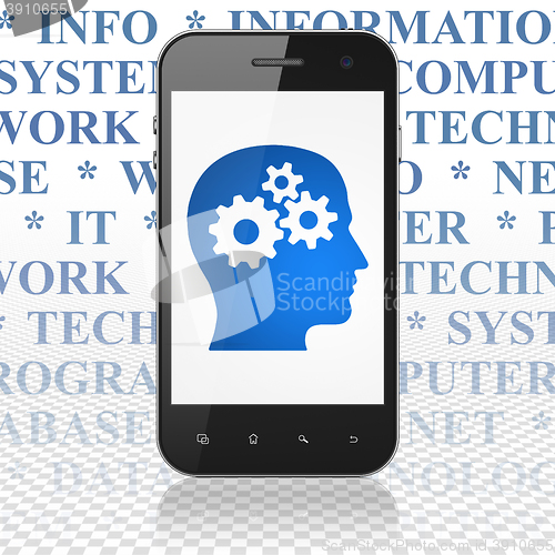 Image of Data concept: Smartphone with Head With Gears on display