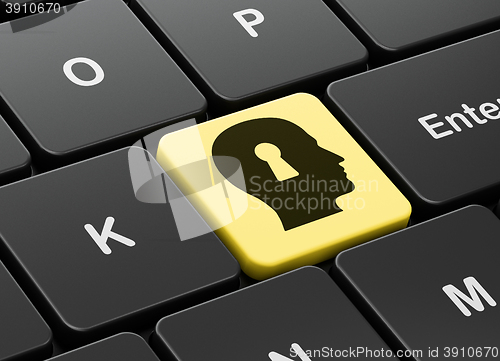 Image of Information concept: Head With Keyhole on computer keyboard background