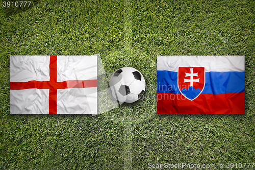 Image of England vs. Slovakia flags on soccer field