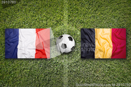 Image of France vs. Belgium flags on soccer field