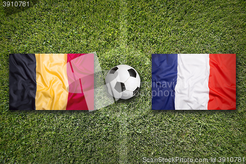 Image of Belgium vs. France flags on soccer field