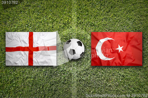 Image of England vs. Turkey flags on soccer field