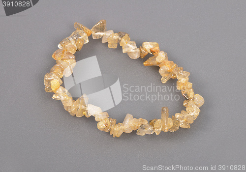 Image of Splintered rutile quartz chain on gray background