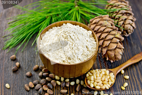 Image of Flour cedar in wooden bowl with spoon on board