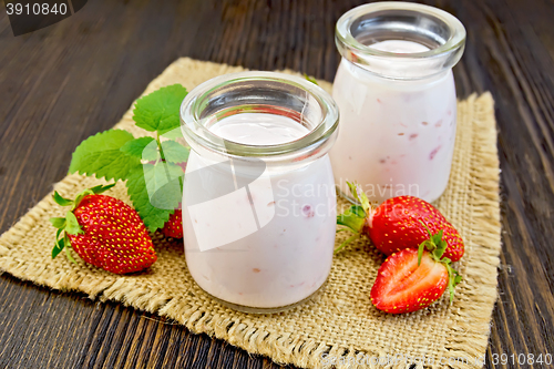 Image of Yogurt with strawberries in jars on sacking