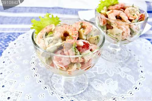 Image of Salad with shrimp and tomatoes in glass on napkin silicone