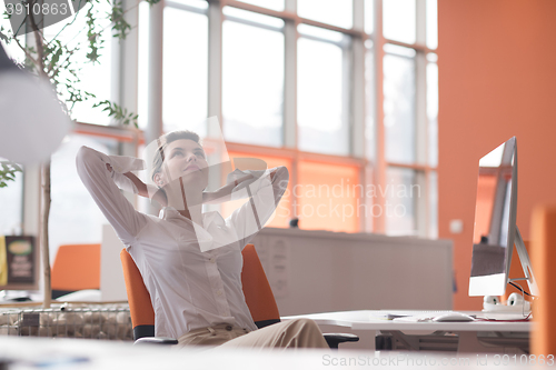 Image of happy young business woman relaxing and geting insiration