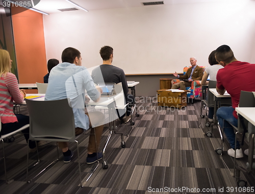 Image of teacher with a group of students in classroom