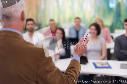 Image of teacher with a group of students in classroom