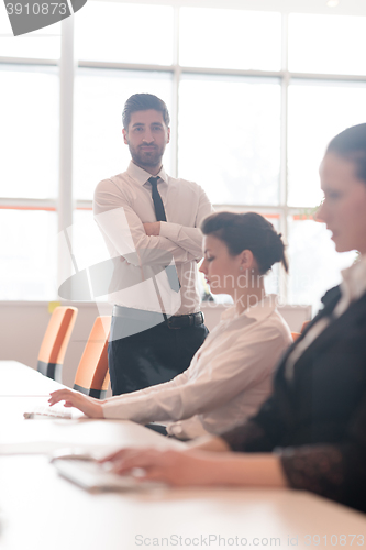 Image of business woman at  office people group in background