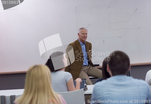 Image of teacher with a group of students in classroom