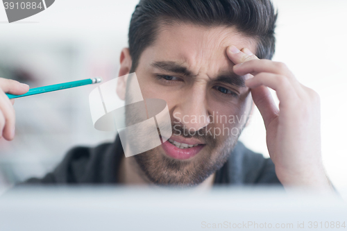 Image of student in school library using laptop for research