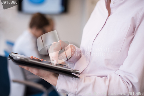 Image of hispanic businesswoman with tablet at meeting room