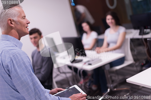 Image of teacher and students in computer lab classroom