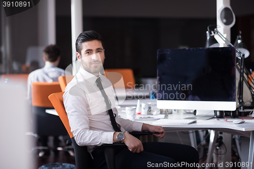 Image of young business man  working on desktop computer