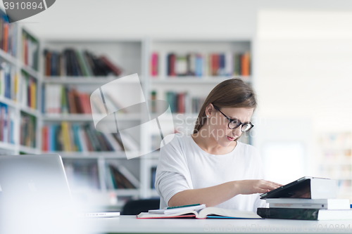 Image of female student study in school library