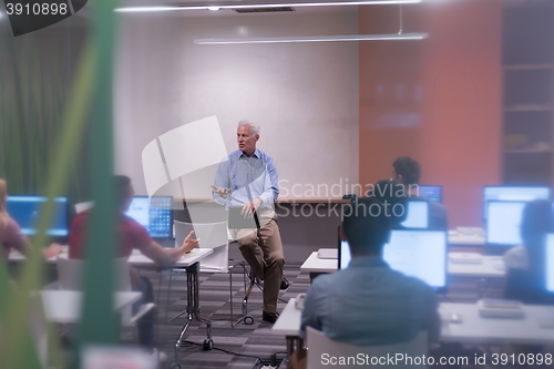 Image of teacher and students in computer lab classroom