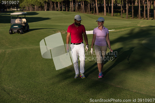 Image of couple walking on golf course