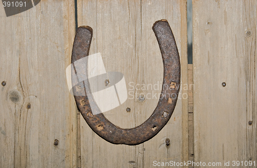 Image of old horshoe on wooden wall