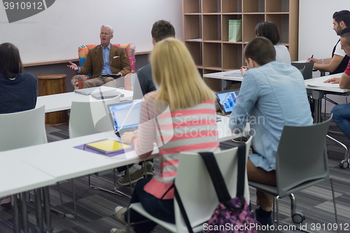 Image of teacher with a group of students in classroom