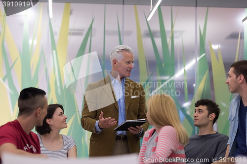 Image of teacher with a group of students in classroom