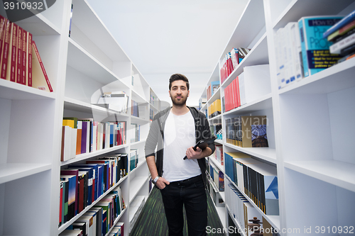 Image of student with tablet in library