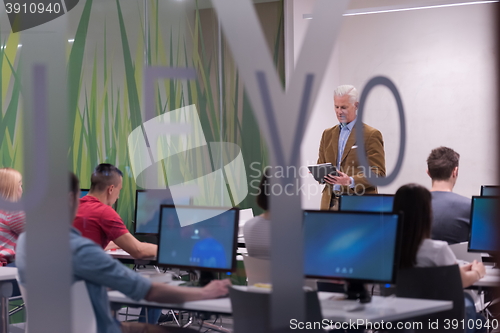 Image of teacher and students in computer lab classroom