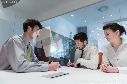 Image of young couple signing contract documents on partners back