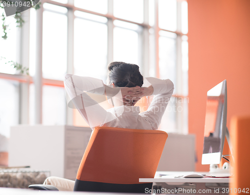 Image of happy young business woman relaxing and geting insiration