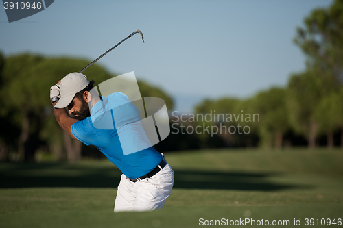 Image of pro golfer hitting a sand bunker shot