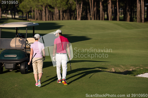 Image of couple walking on golf course