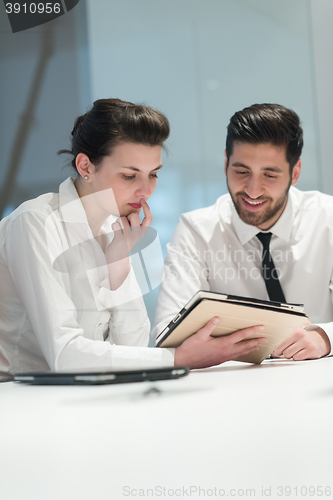 Image of young business couple working together on project