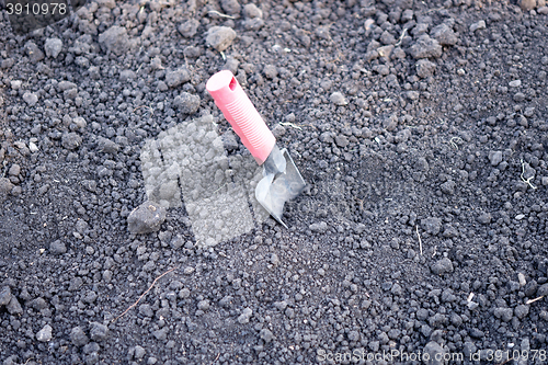 Image of shovel in soil