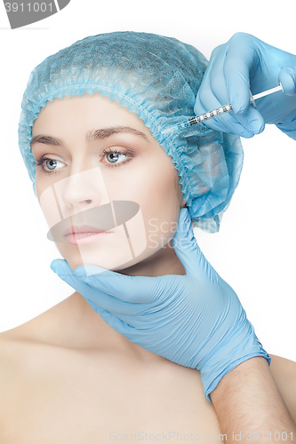 Image of Attractive woman at plastic surgery with syringe in her face