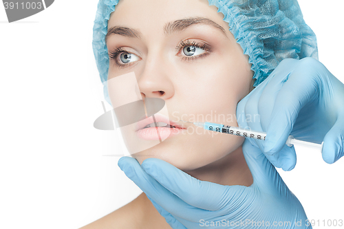 Image of Attractive woman at plastic surgery with syringe in her face