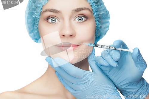 Image of Attractive woman at plastic surgery with syringe in her face